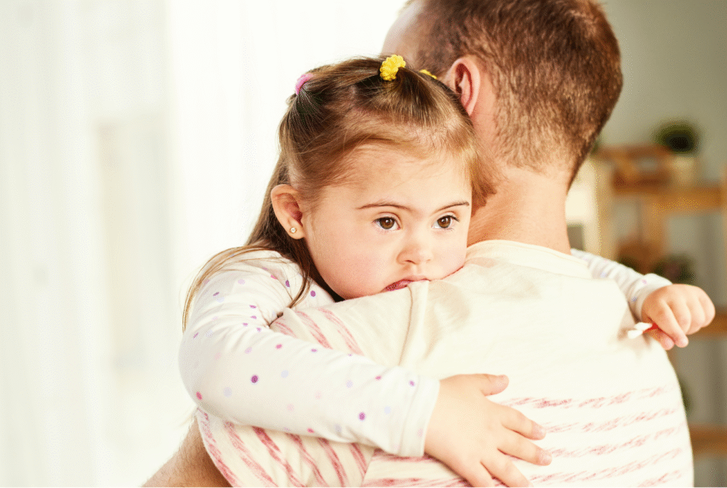 A child being held by a parent
